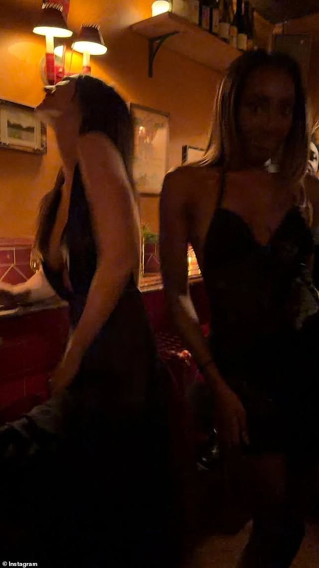 A Christmas Tree Backdrop, Emily Flaunts a Plunging Black Dress and a Wine Glass